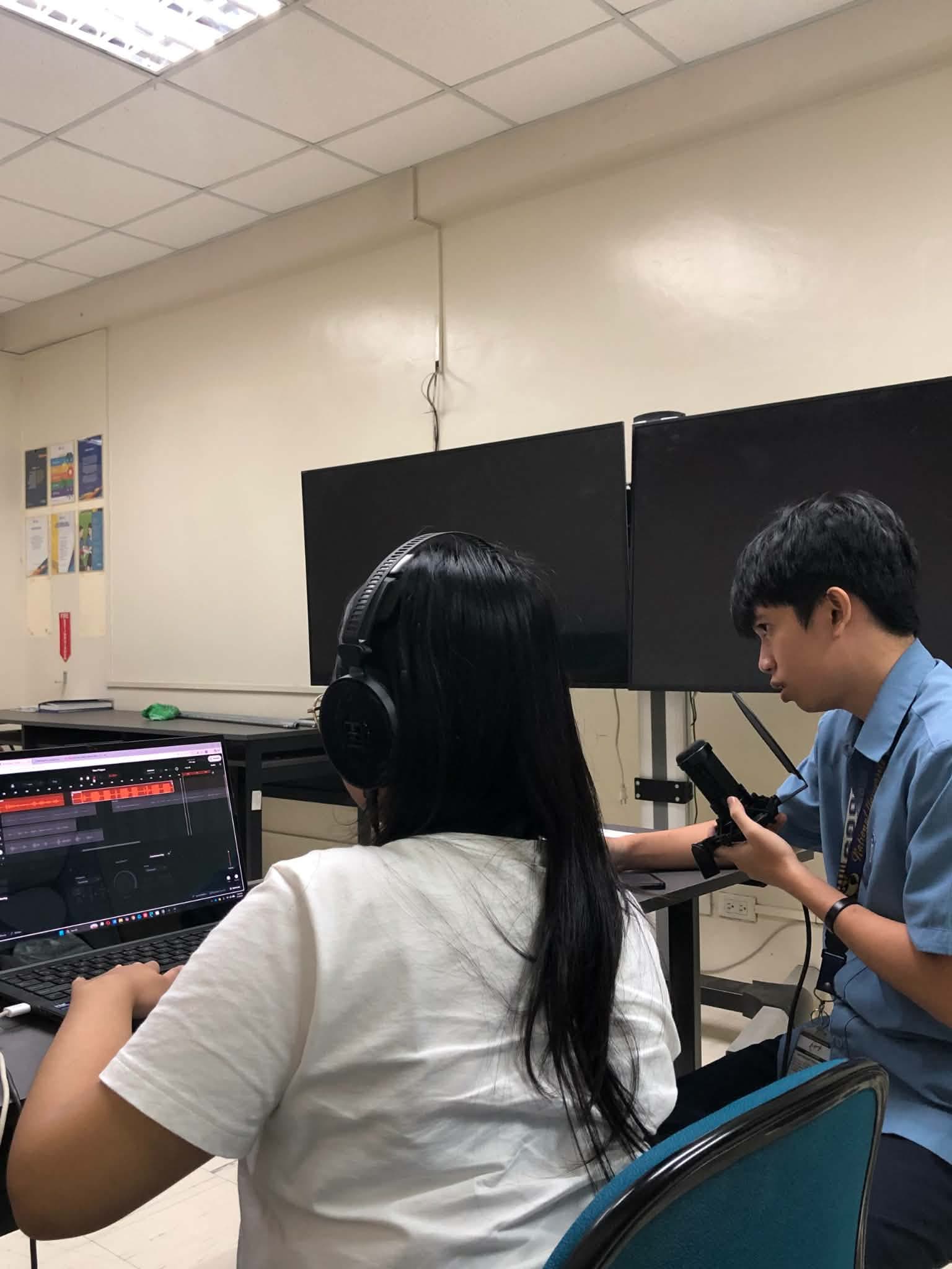 Team members recording and editing audio for NGINIG in the production lab